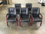 Five black office chairs