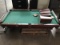 Green top disassembled pool table