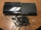 Two PlayStation 3s with cables