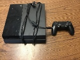 PlayStation 4 with controller and cables