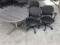 Three black office chairs with round lobby table