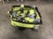 Green bag with power tools drill, saws, flashlight, measuring tape, battery