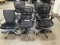 Five black office chairs