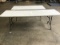Two white top folding tables