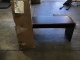 Brown office table with unassembled bookcase with doors