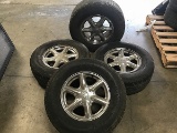Four tires with Cadillac rims