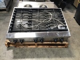 Kitchen air extracting hood with stove top