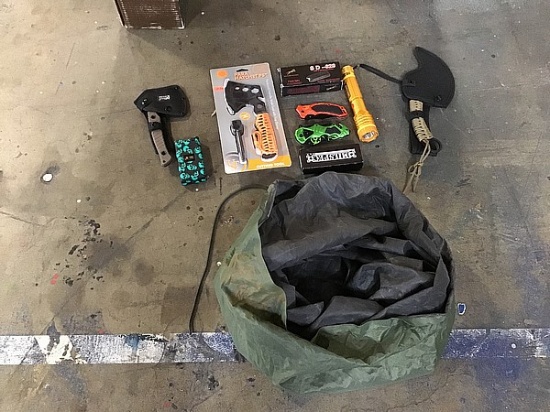 Camping equipment: green bag, knives, flashlight, stun gun