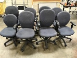 Eight blue office chairs