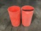 Two orange plastic trash cans