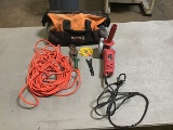 Orange and black bag with electric grinder, cutting scissors Orange extension cord