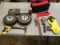 2 rubber tires, black/red emergency road kit, , 2 boxes of saw blades, 2 pipe wrenches, hacksaw