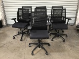 Seven black office chairs