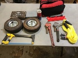 2 rubber tires, black/red emergency road kit, , 2 boxes of saw blades, 2 pipe wrenches, hacksaw