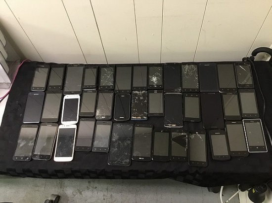 Box of cellphones, possibly locked, no chargers, some damage