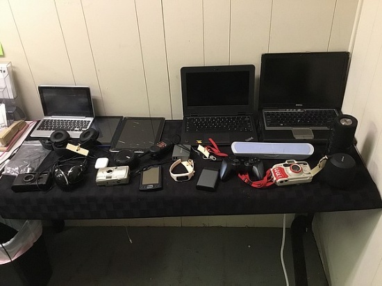 Speakers, power bank, cameras, headphones, fit tracker Computer, tablets,  possibly locked some dama