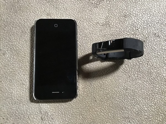 One Cellular phone and one black fitBit