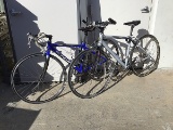 Two bikes (Blue schwinn, gray road bike)