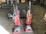 4 red Sanitaire commercial vacuums