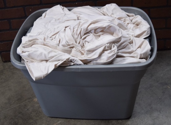 Plastic Tote Full Of White Spandex Truss Covers