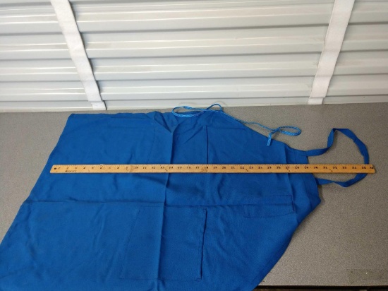 Large plastic tote full of blue aprons