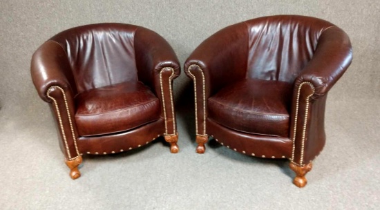 Two leather riveted club chairs