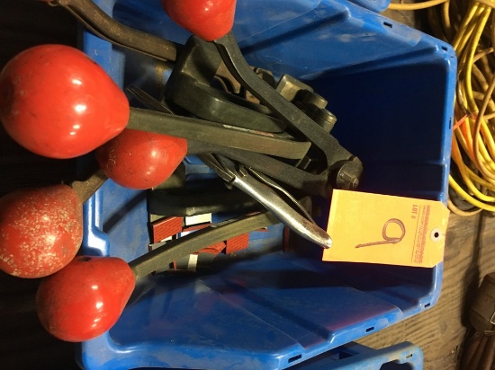 Plastic tub of banding tools.