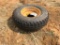 Firestone 11L-16 tire on 8-hole rim.