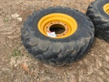 Goodyear 12.5-80-18 tire on 8-hole rim.