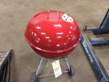 Red Weber charcoal grill.
