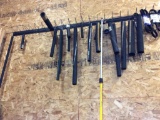 Water hose, fan belts on wall w/ removal rod & rack.