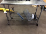 Stainless steel top work table on casters.