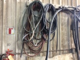 Hydraulic & air hose on wall.