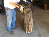 New Recap 11 R25 tire on rim.