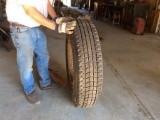 New Recap 11 R25 tire on rim.