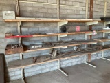 Items on shelves: rollers, chain, debarker & saw.