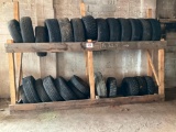 Lot of assorted tires and wood rack.