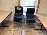 6 - black plastic stacking chairs.