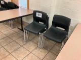 6 - black plastic stacking chairs.
