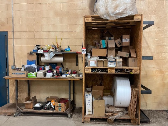 Shipping center w/ table on casters, shelving and related items.