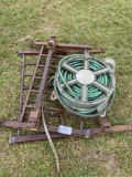 small metal bed frame and hose reel