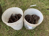 2 buckets of horse shoes