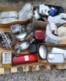 Pallet of antique car, lights and emblems