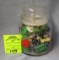 Glass jar full of vintage toys and collectibles