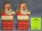 Pair of early Die-cut season’s greetings Santa penny banks