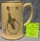 Early Penny Farthing high wheel bicycle advertising beer mug