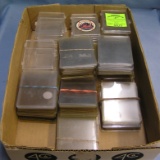 Box full of trading card protective cases and sleeves