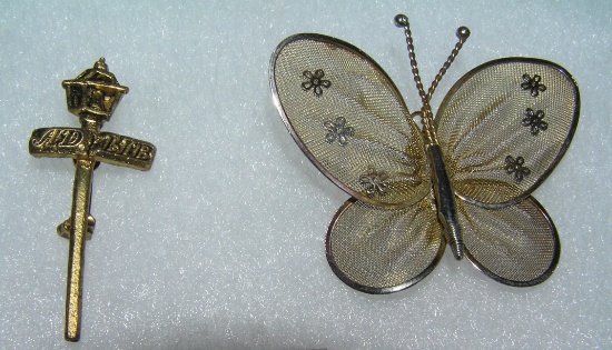 Pair of costume jewelry pins includes lamp post and butterfly