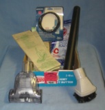 Box full of vacuum cleaner parts and accessories