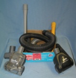 Box full of vacuum cleaner parts and accessories